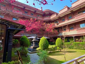 A courtyard with a central fountain, surrounded by neatly trimmed bushes and trees. - Hotel Siddhi Manakamana (Kathmandu)