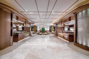 A spacious hotel lobby with a central seating area, multiple service counters, and a modern ceiling design. - Leodikya Kirman Premium - Ultra All Inclusive (Alanya)