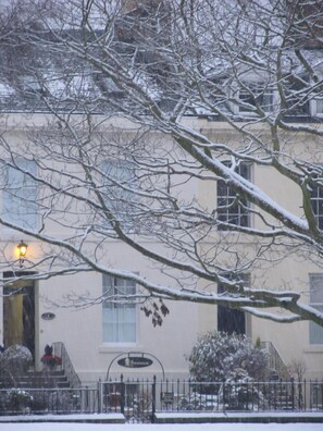 A building with a snow-covered entrance, a visible staircase, and a sign that reads "Hotel". - The Townhouse (Perth)