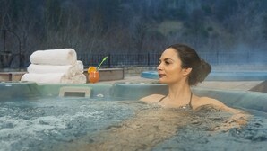A person in a hot tub with a towel and a drink on the side. - St. Spas Hotel & Balneo Complex (Velingrad)