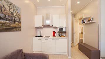 Deluxe appartement, balkon | Woonruimte | Flatscreentelevisie