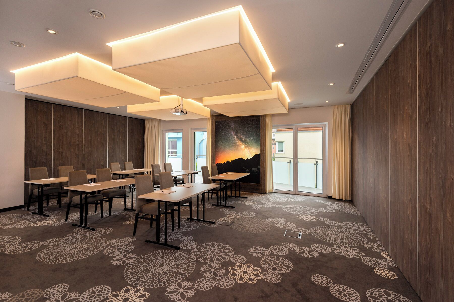 A conference room with a large table, chairs, and a projector.
