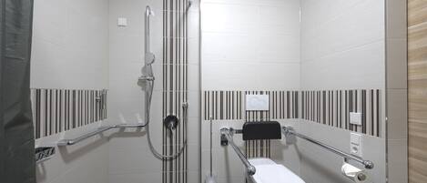 A modern bathroom with a shower, toilet, and grab bars.