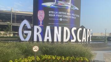 A large outdoor sign for "GRANDSCPACE" with a digital display advertising "Stella Artois" and a partnership with OpenTable.