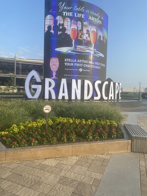 A large outdoor sign for "GRANDSCPACE" with a digital display advertising "Stella Artois" and a partnership with OpenTable. - Staybridge Suites Plano - The Colony by IHG (The Colony)