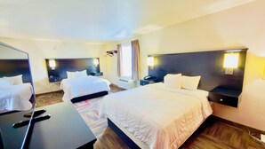 A hotel room with two beds, a desk, and a mirror. - Black Gold Suites Tioga (Tioga)