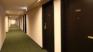 A hotel corridor with dark wooden doors numbered 502 and 503, carpeted floors, and recessed ceiling lighting. - Hotel Crown Hills Kimitsu (Kimitsu)