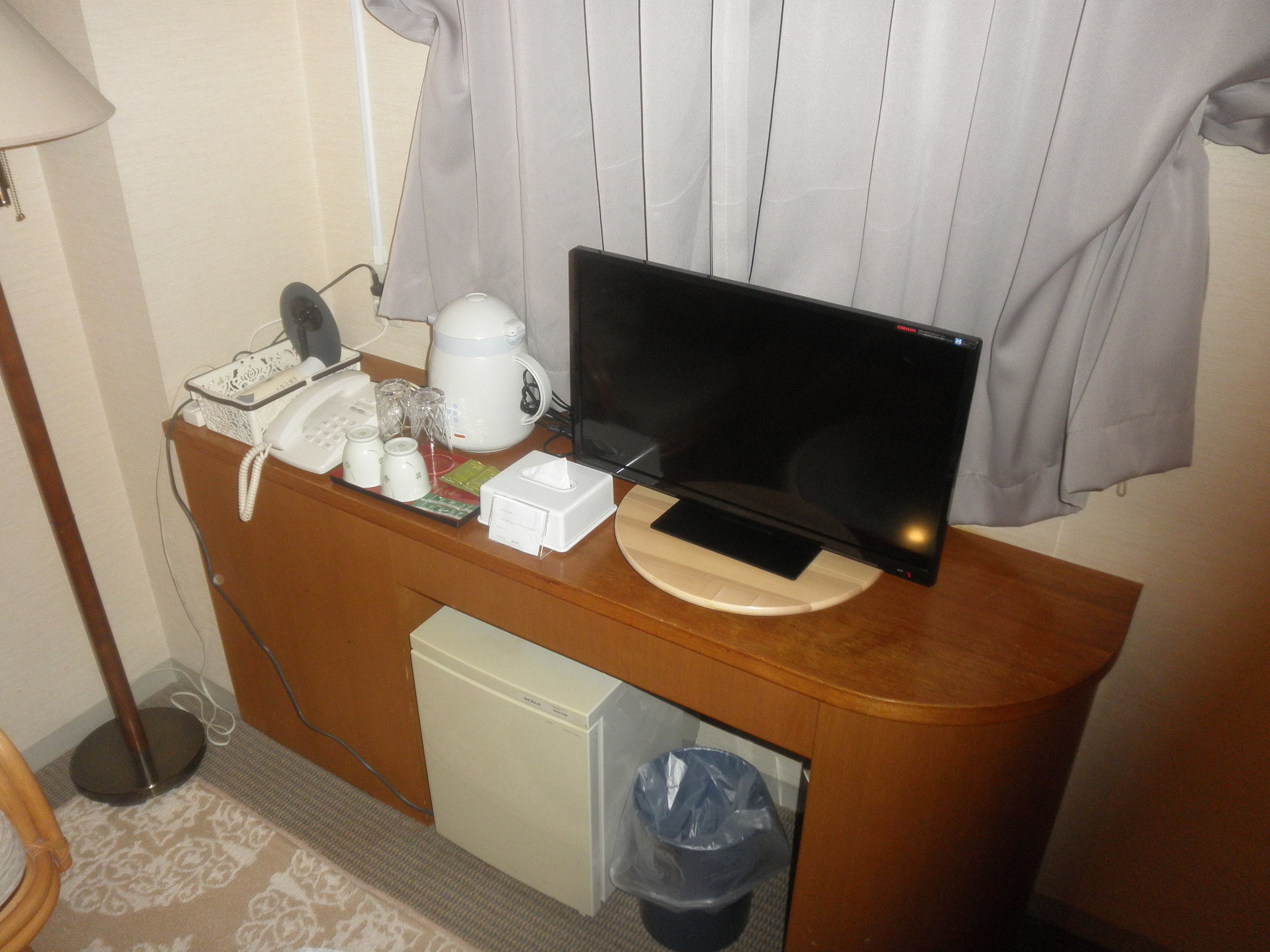 A small kitchenette with a microwave, coffee maker, and a small refrigerator.