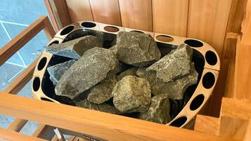 A wooden chair with a metal frame and a cushion filled with rocks.