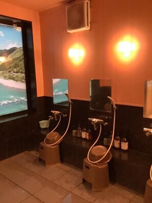 A bathroom with two sinks, a large window with a view of the sea, and a mirror above the sinks. - Hotel Crown Hills Nakamura (Shimanto)
