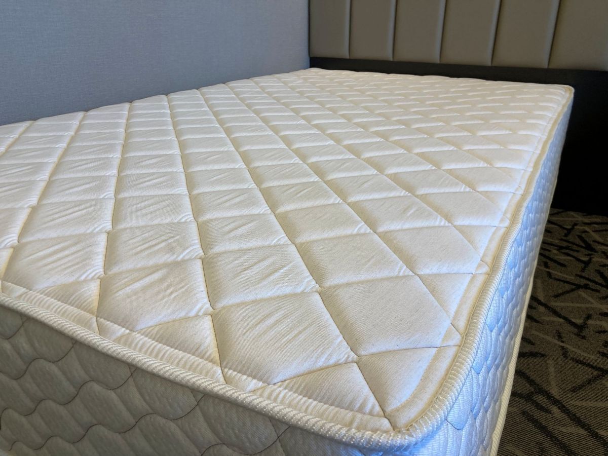 A mattress with a quilted top and a patterned bottom.