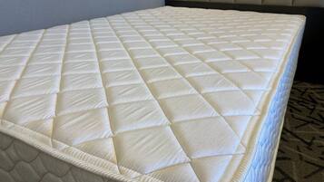 A mattress with a quilted top and a patterned bottom.