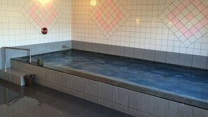 A rectangular hot tub with a tiled wall featuring diamond patterns and a digital thermometer. - Hotel Crown Hills Takaoka (Takaoka)