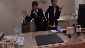A hotel reception desk with a sign for Hotel Crown Hills Takenfu, a computer, and some office supplies. - Hotel Crown Hills Takefu (Echizen)