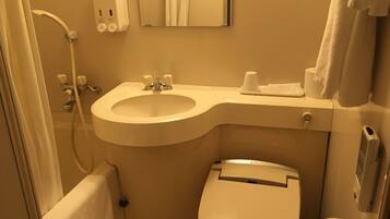 A compact bathroom with a sink, toilet, and a hand dryer.