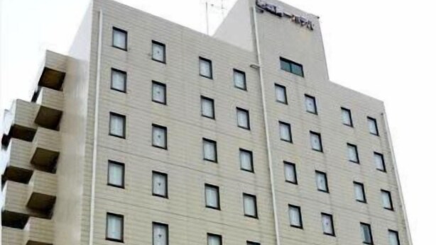 A multi-story hotel with a uniform facade, numerous windows, and balconies.