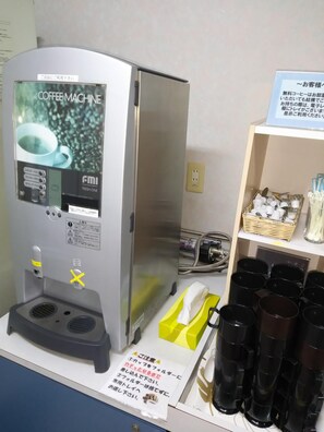 A coffee machine with a digital display, a water dispenser, and a coffee pod holder. - Hotel Hyper Hills Hirosaki (Hirosaki)
