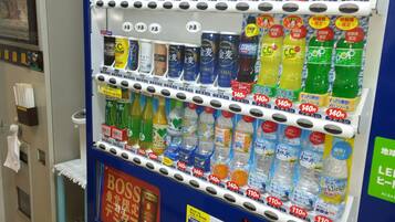 A vending machine with various drinks and snacks, including bottles of water, sodas, and other beverages.
