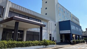 A hotel with a modern facade, a covered entrance, and a sign indicating it is the Hotel Crown Hills Miyoshi. - Hotel CROWN HILLS MIYOSHI (Miyoshi)
