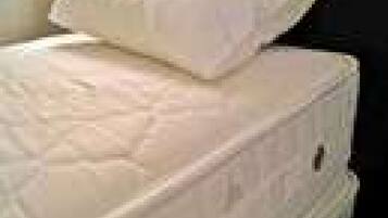 A stack of mattresses with a visible mattress on top.