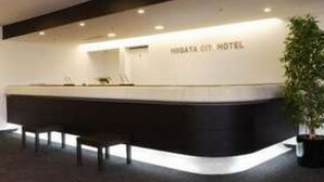 A reception desk with a sign that reads "Higaya City Hotel."