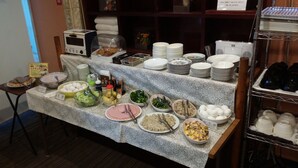 A buffet setup with various food items and condiments. - Hotel Onahama Hills (Iwaki)