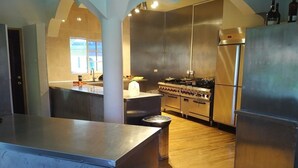 Una cocina moderna con electrodomésticos de acero inoxidable, una isla central y un amplio ventanal que aporta luz natural.
