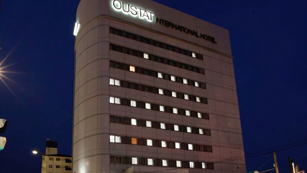 A modern hotel building with a sign reading "Oustat International Hotel". - Oustat International Hotel Tajimi (Tajimi)