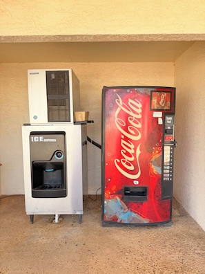 A vending machine with a Coca-Cola logo and a water dispenser on top. - Royal Inn Pearsall (Pearsall)