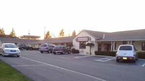 A parking lot with several cars parked in front of a building labeled "Black Forest Inn." - Black Forest Inn of Adamstown (Adamstown)
