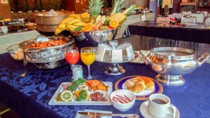 A buffet table with various food items and beverages, including fruits, vegetables, and pastries. - Kai Resort Hotel (Fuefuki)