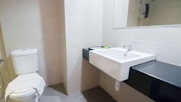 Een badkamer met toilet, wastafel en douche.