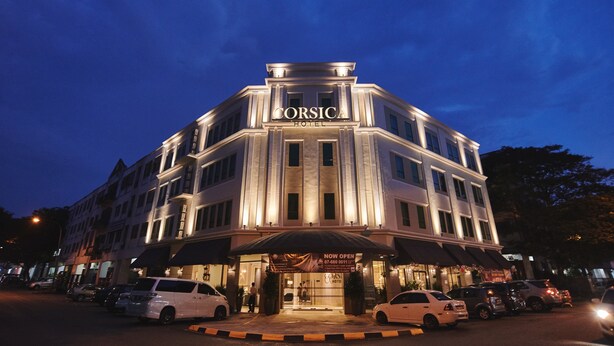 A hotel with a prominent sign reading "CORSICA HOTEL" and a banner stating "NOW OPEN 07-060 0911". - Corsica Hotel (Kulai)