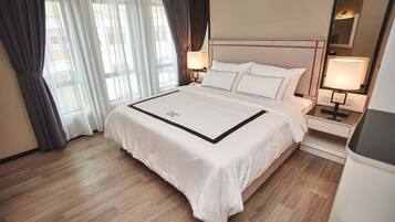 Cozy retreat with a large bed, bedside tables, and a mirror.