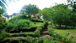 A garden with a stone staircase leading up to a house. - The Kandyan Villa (Kandy)