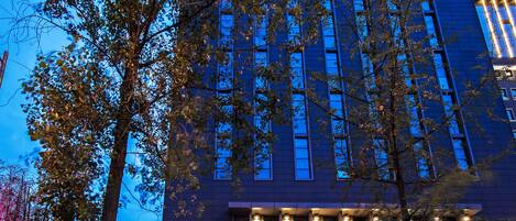 A tall hotel building with a sign that reads "SKYTEL".