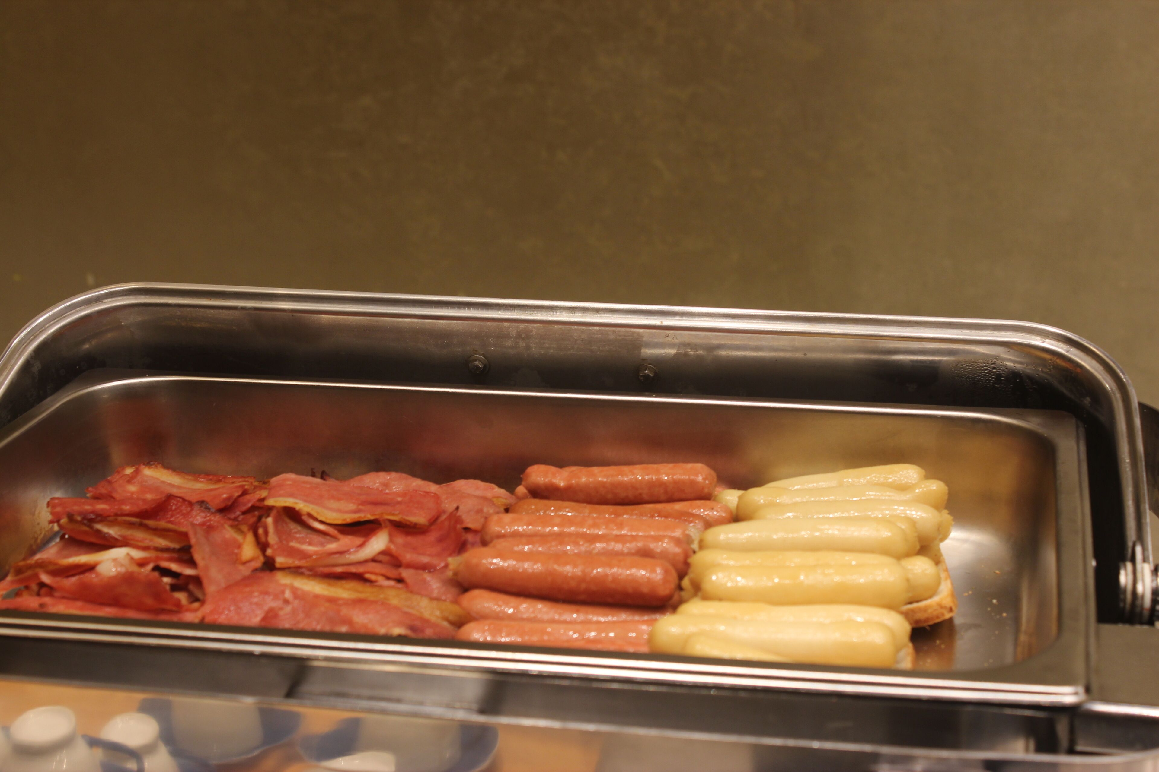 A buffet with various meats and cheeses.