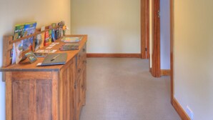 A hallway with a wooden reception desk, a ceiling light fixture, and a carpeted floor. - Ashdowns of Dover B&B (Dover)