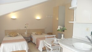 A hotel room with two beds, a small dining table, a sink, and a mirror. - Club Atrium Marmaris (Marmaris)