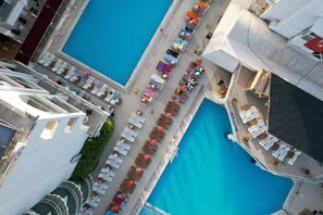 An aerial view of a hotel with two swimming pools, arranged seating areas, and a covered walkway. - Club Atrium Marmaris (Marmaris)