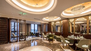 A luxurious dining area with marble floors, elegant chandeliers, and a view of the cityscape. - Qianjiang Junting Hotel, Haining (Jiaxing)