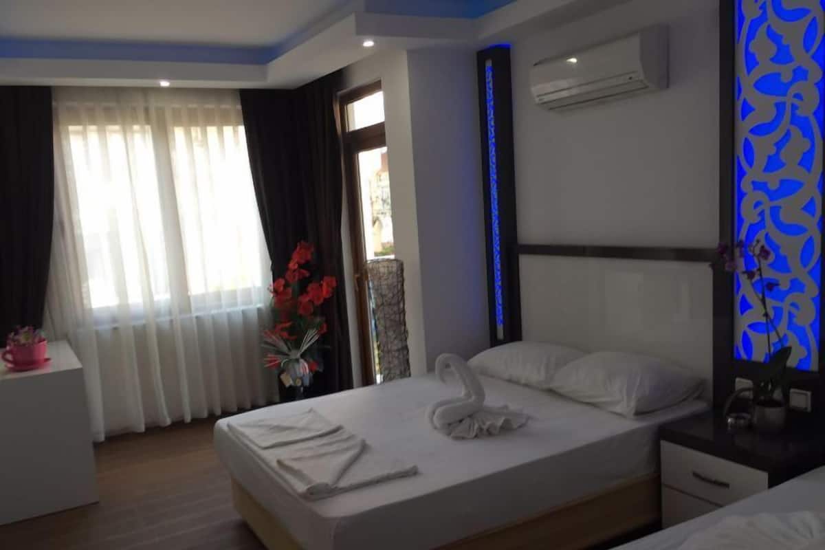 Standard Triple Room | Minibar, in-room safe, desk, iron/ironing board
