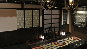 A traditional interior with a table set for dining, wooden chairs, and a decorative lantern. - Yadoya Kyoto-Shimogamo (Kyoto)