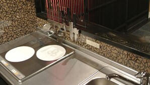 A kitchen with two stainless steel sinks, a black refrigerator, and a patterned backsplash. - Yadoya Kyoto-Shimogamo (Kyoto)