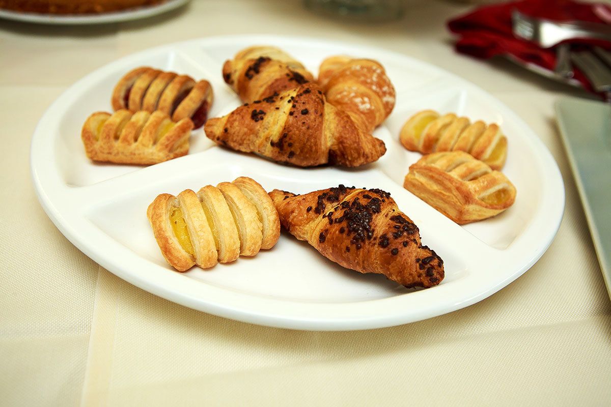 A plate of assorted pastries on a white plate.