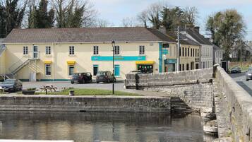 A building with a sign reading "CENTRA" and a staircase leading down to a canal.