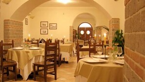 A restaurant with tables set for dining, featuring an arched ceiling and brick walls. - Casa Scola Agriturismo (Gragnano)