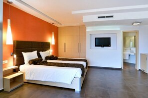 A modern hotel room with a large bed, a TV mounted on the wall, and a separate bathroom area. - LTI Dolce Vita Sunshine Resort (Golden Sands)