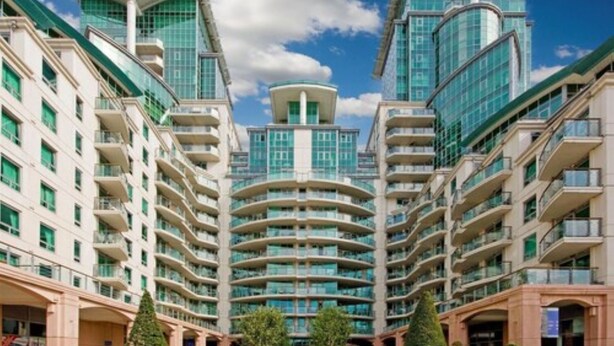 A modern high-rise building with multiple balconies and a central tower. - NG Apartments London (London)