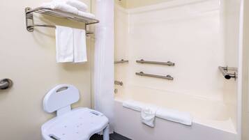 A bathroom with a shower, a toilet, and a towel rack.